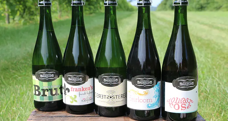 Fünf Flaschen Sekt in einer Holzkiste