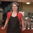 Eine Frau steht vor ihrem Geschäft