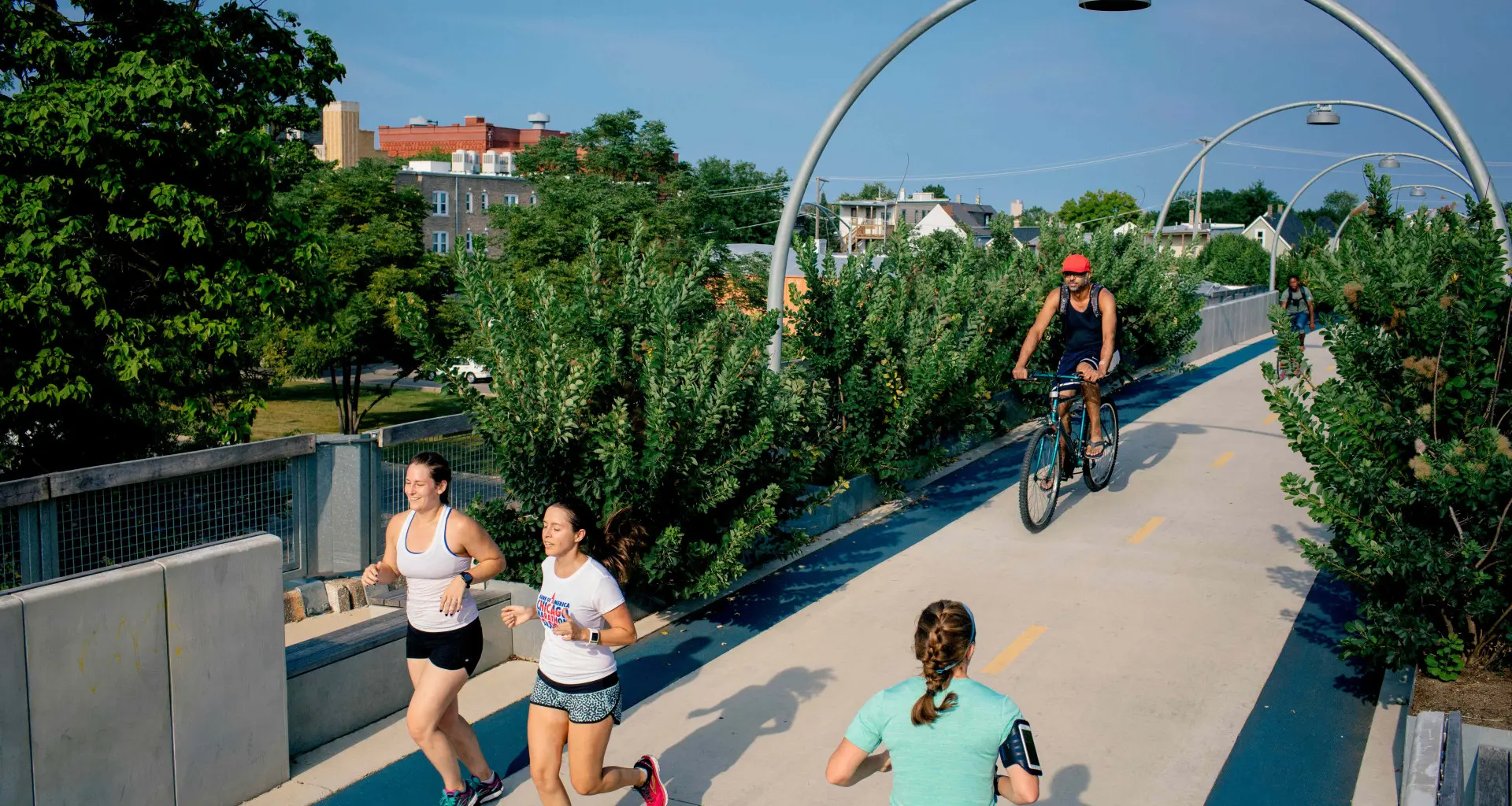 Laufende und radfahrende Menschen auf der Fahrradbrücke