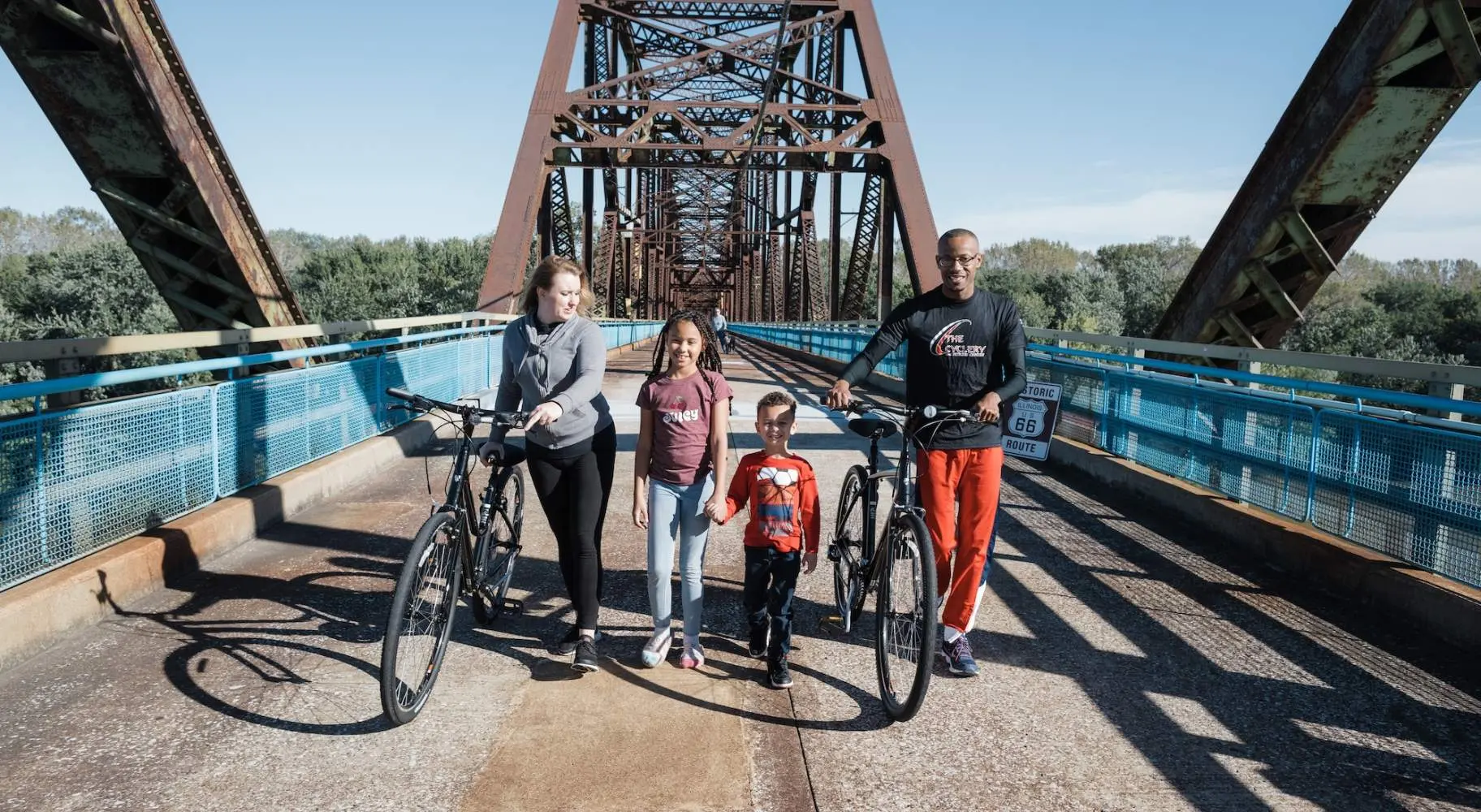 Familie mit Fahrrädern auf einer Brücke